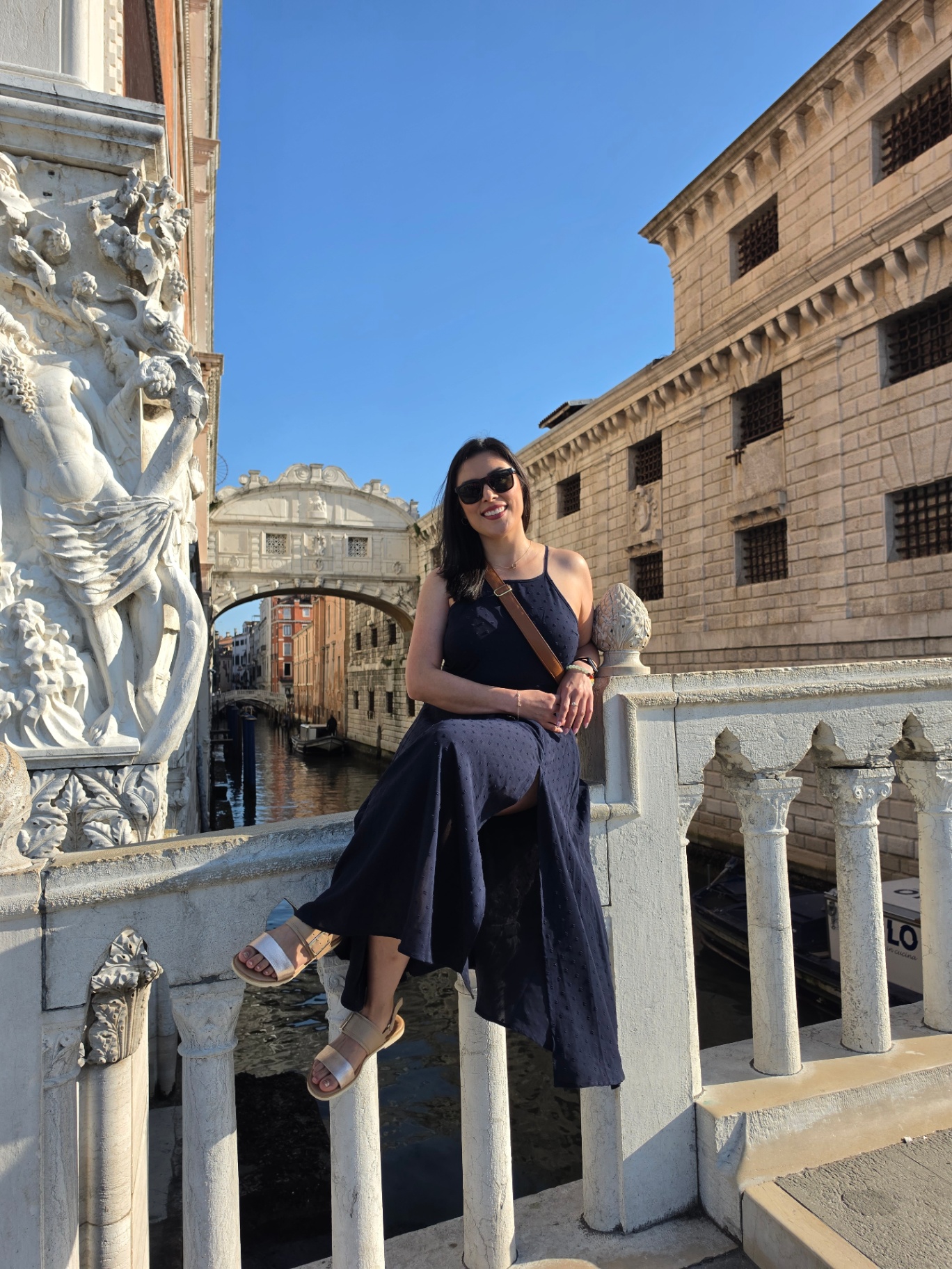 Woman seated by the Bridge of Sighs in Venice
