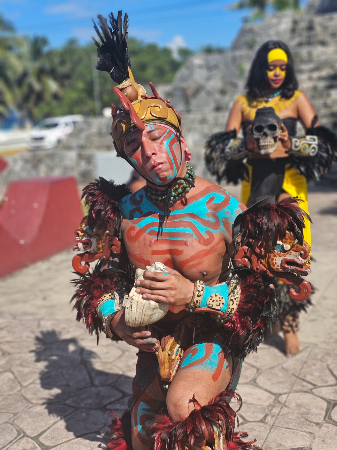 Mayan performer holding a conch shell