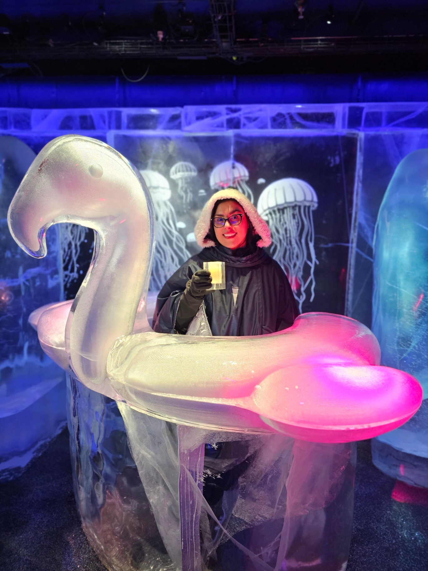 Woman with a drink beside an ice sculpture