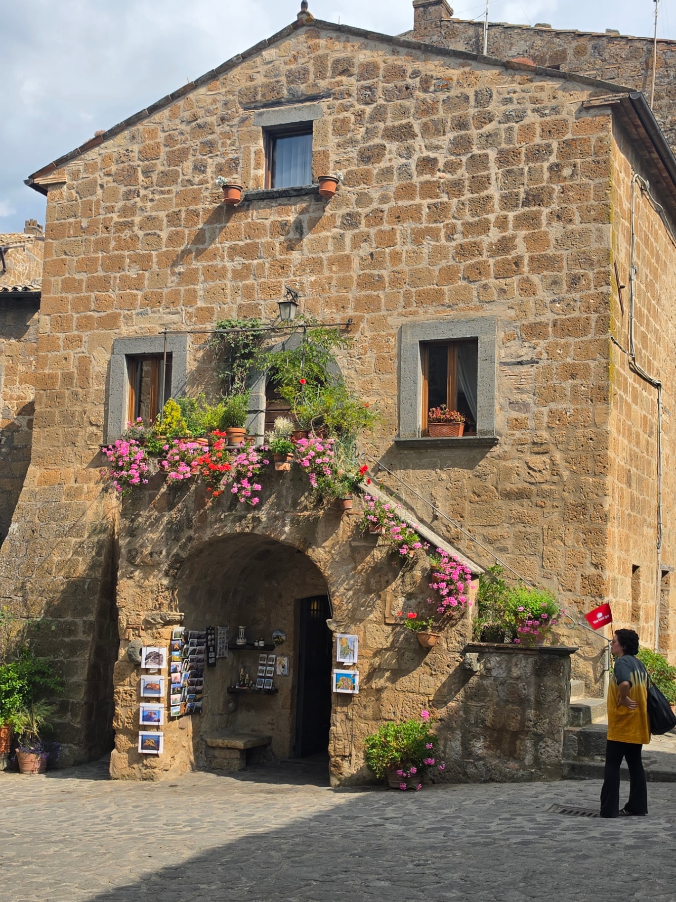 Stone building with flower-lined stairs