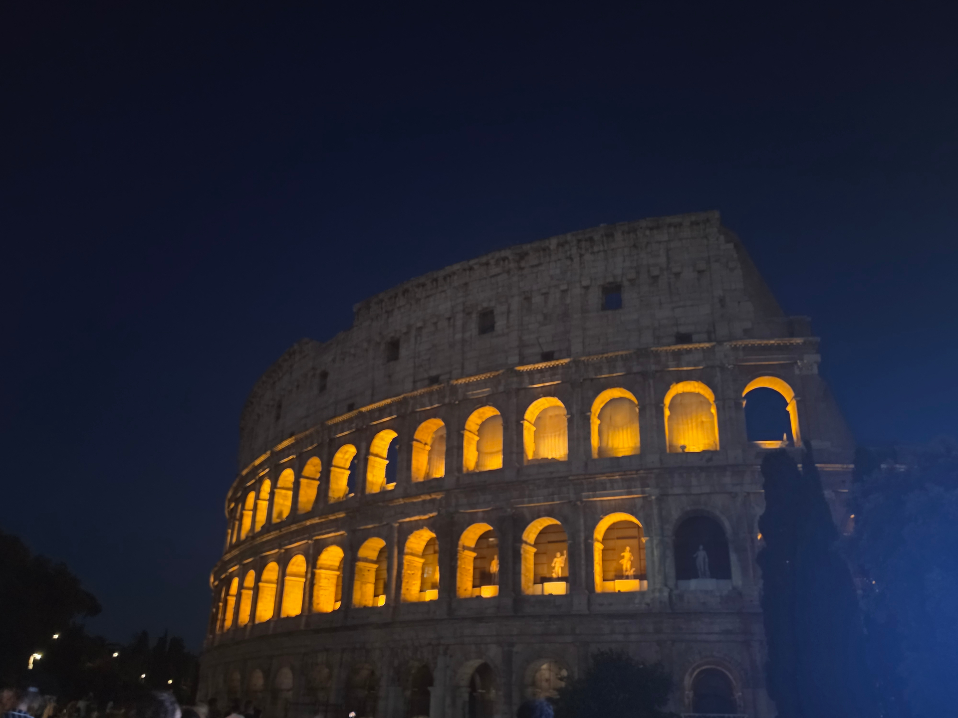The Colosseum in Rome glowing at night