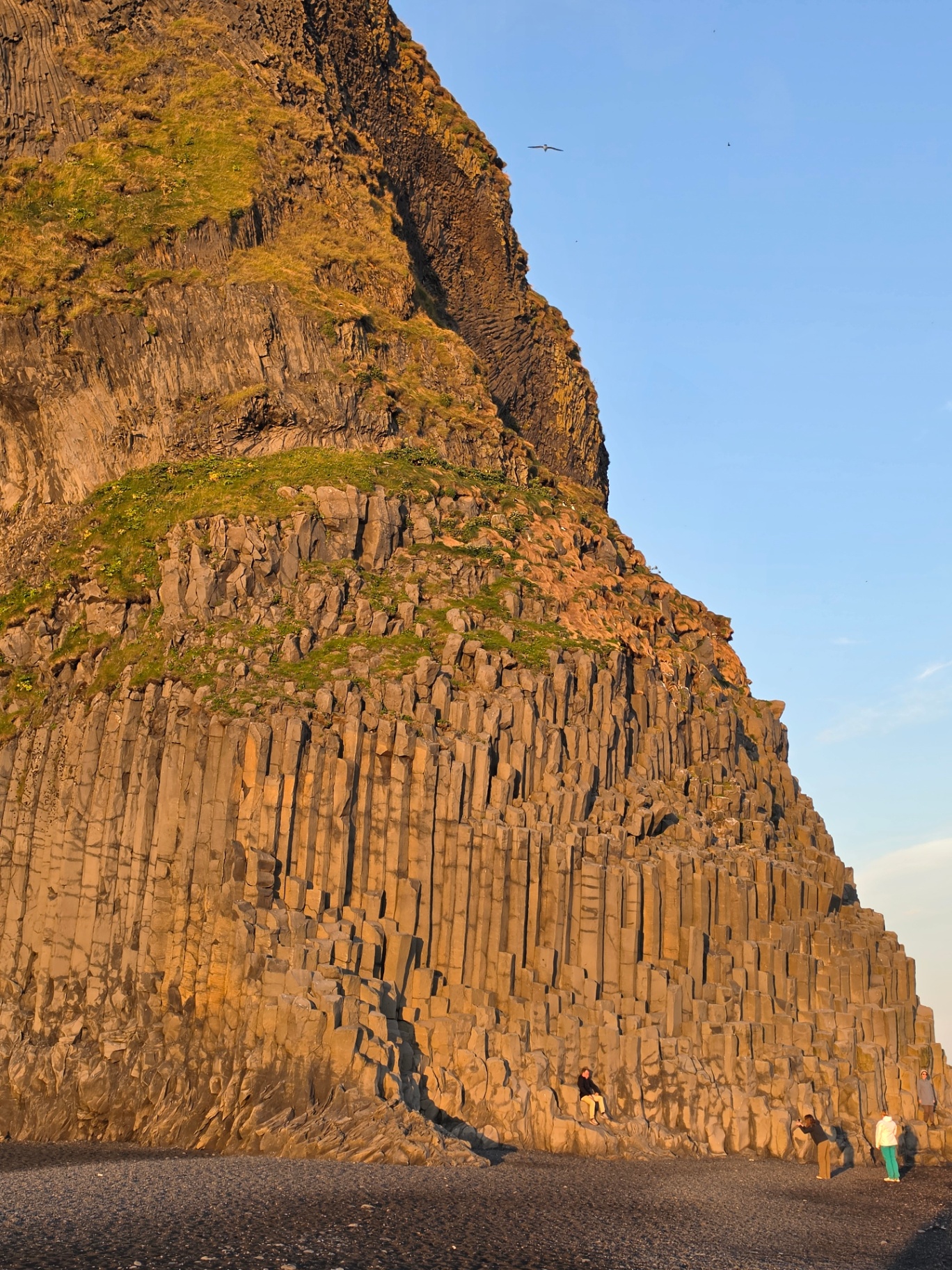 Golden light on the basalt columns above Reynisfjara black sand beach