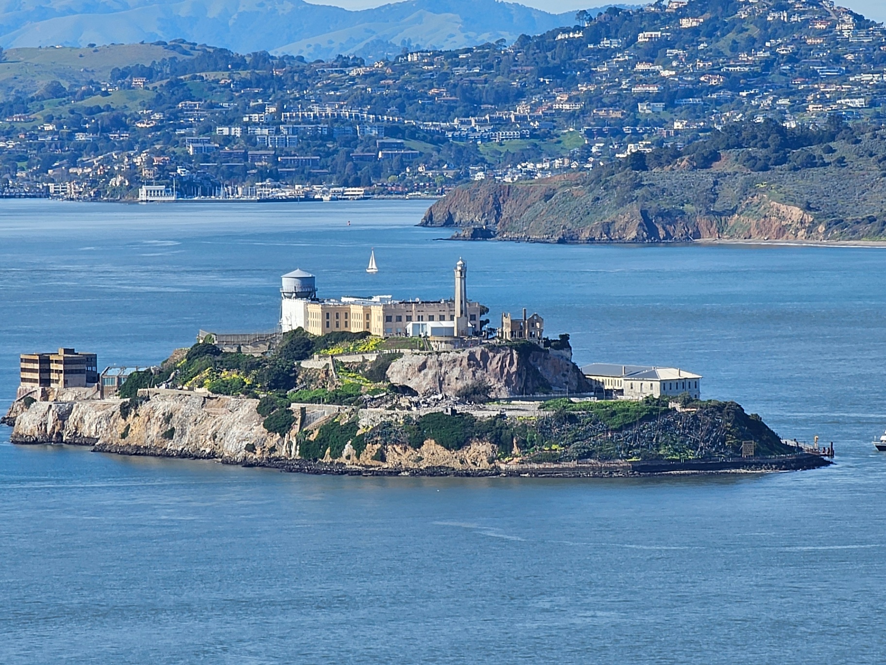 Alcatraz Island in San Francisco Bay with hills behind it
